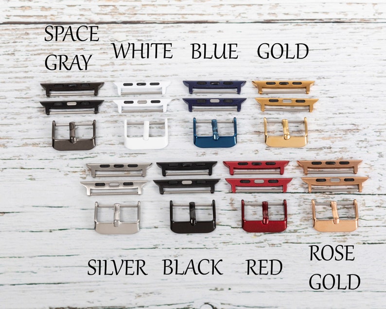 May include: A variety of watch band adapters in different colors, including space gray, white, blue, gold, silver, black, red, and rose gold. The adapters are arranged in two rows of four, with the colors labeled above each row.