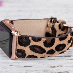 May include: A rose gold Apple Watch with a brown and black leopard print band.