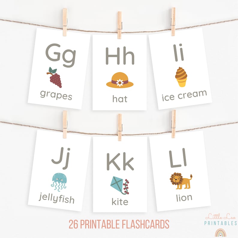 May include: A set of 26 printable flashcards featuring the alphabet with corresponding illustrations. The flashcards include letters G, H, I, J, K, and L with images of grapes, a hat, ice cream, a jellyfish, a kite, and a lion.