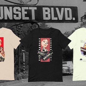 May include: Three t-shirts with different designs featuring the film "Sunset Boulevard". The first t-shirt is beige with a red and black design. The second t-shirt is black with a red and black design. The third t-shirt is white with a red, black, and blue design. All three t-shirts feature the title "Sunset Boulevard" and a film strip.
