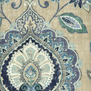 May include: A beige fabric with a blue and green paisley pattern. The pattern features intricate details and a distressed look.
