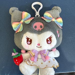 May include: A set of three ceramic mugs with a speckled, matte finish. The mugs are in shades of cream, light gray, and dark gray. Each mug has a simple, minimalist design and a rounded handle.