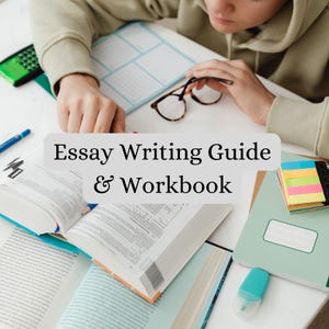 Op de afbeelding: Een open werkboek en gids met de tekst "Essay Writing Guide & Workbook" is omringd door andere boeken, een rekenmachine en een bril. Een persoon werkt aan de materialen. De scène speelt zich af op een wit oppervlak.