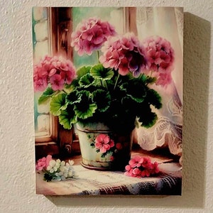 May include: A painting of a potted plant with pink flowers in a windowsill setting. The plant is in a white and blue floral pot with green leaves. The window is behind the plant and has a white lace curtain.