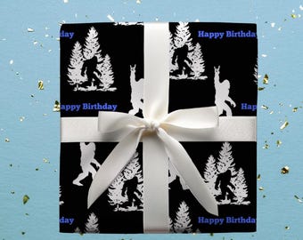 May include: Black and white wrapping paper with a repeating pattern of Bigfoot and trees. The text "Happy Birthday" is printed in blue on the paper.