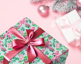 Papel de regalo navideño Coquette, lazos rosas y vegetación festiva