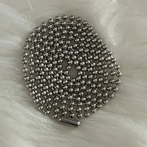 May include: A silver ball chain necklace with a silver clasp.