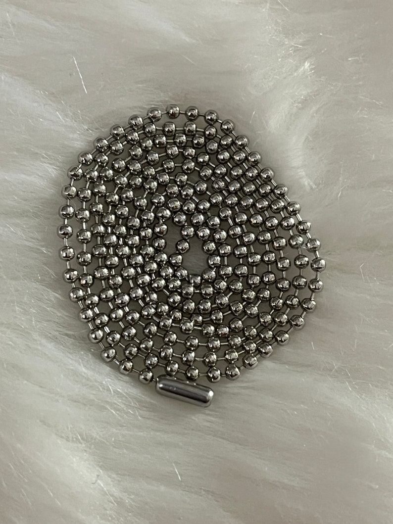 May include: A silver ball chain necklace with a silver clasp.