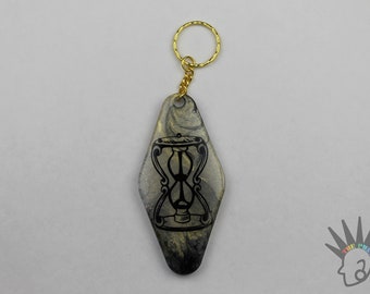 Hourglass Motel Resin Keychain in Black and Gold