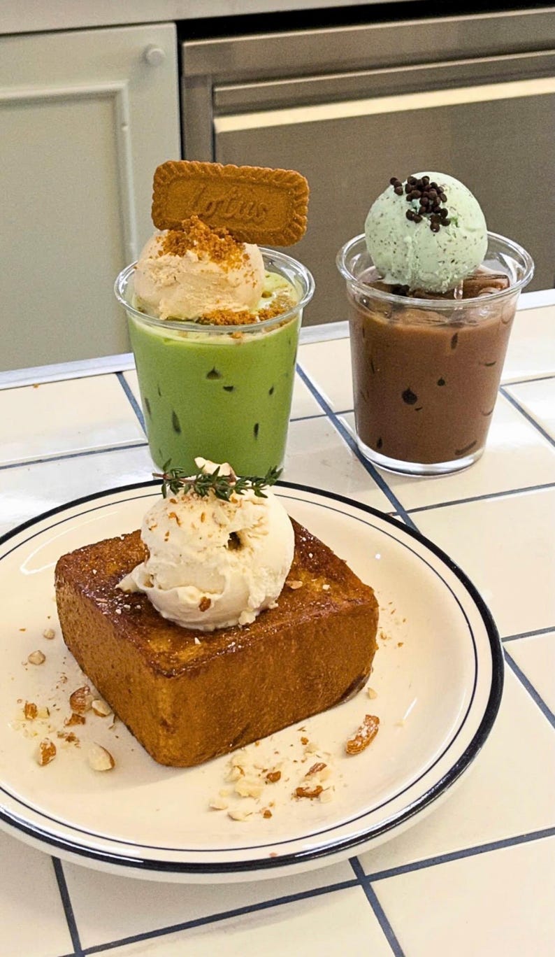 May include: An overhead shot of three desserts. A slice of golden-brown toast topped with ice cream and nuts sits on a plate. Two clear cups hold drinks, one green with ice cream and a cookie, the other brown with mint ice cream.