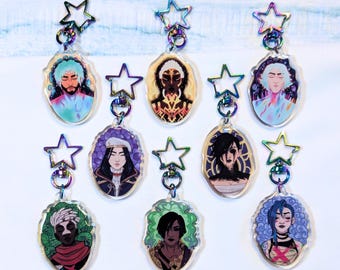 May include: Eight acrylic keychains featuring diverse illustrated character portraits, each attached to a rainbow-colored star-shaped metal clasp. The designs include various figures with distinct hair colors, facial markings, and detailed clothing styles.