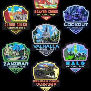 May include: A collection of seven shield-shaped embroidered patches featuring colorful illustrations of fictional landscapes. Each patch displays a unique location name like Blood Gulch, Beaver Creek, Lockout, Valhalla, Zanzibar, Halo, and Pelican Drop Trailhead.