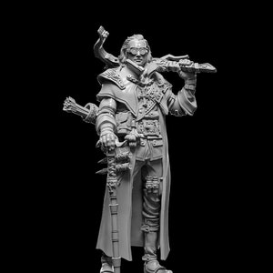 May include: A gray, detailed miniature figurine of a man wearing a long coat, goggles, and holding a sword and a staff. The figurine is standing on a round base.