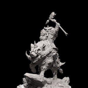 May include: A white 3D printed miniature of a warrior riding a boar. The warrior is holding a large axe and wearing armor. The boar is also armored and has tusks. The miniature is set on a circular base with a rocky terrain.