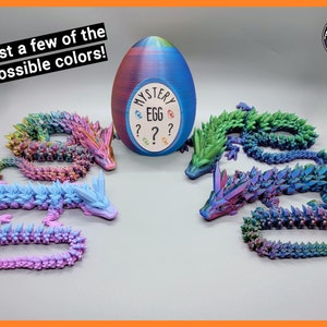 May include: A close-up of a mystery egg with a question mark and the word "Mystery Egg" printed on it.  Four iridescent dragon figurines are shown in different colors: pink, blue, green, and purple.