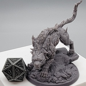 May include: A gray, detailed miniature of a creature with a spiky, scaly body and a long, spiky tail. The creature is standing on a gray, rocky base.