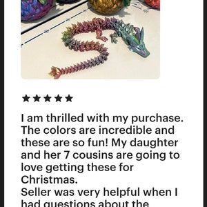 May include: Five iridescent dragon planters with a single dragon planter laying on its side. The planters are made of a textured material and have a variety of colors, including purple, green, gold, and blue.