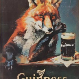 May include: Vintage Guinness advertisement featuring a fox with orange and white fur, resting its paw on a table. A pint of Guinness stout sits on the table. The Guinness logo is displayed prominently.