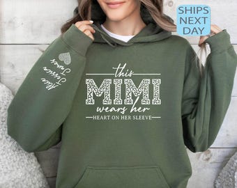 May include: Green hooded sweatshirt with the text "This Mimi wears her heart on her sleeve" in white with a leopard print design. The sleeve has the text "Love, Jessica, some" in white.