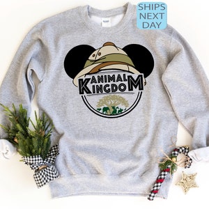 May include: Grey sweatshirt with a Mickey Mouse head design featuring a safari hat and the words "Animal Kingdom".