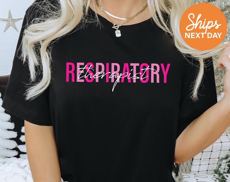 a woman wearing a black shirt with pink lettering