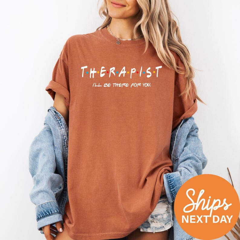 a woman wearing a brown shirt that says therapist
