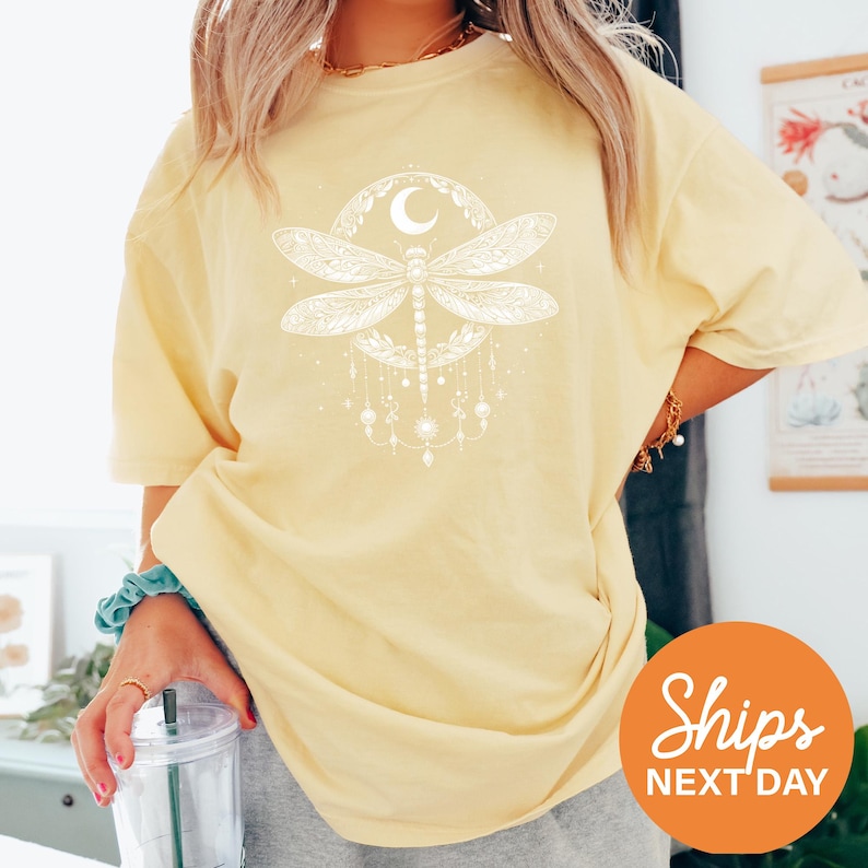 a woman wearing a yellow shirt with a dragon on it