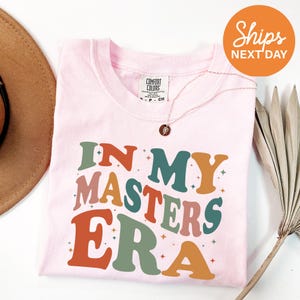 a pink shirt with the words in my masters era on it