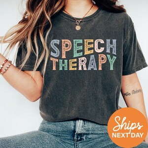 a woman wearing a t - shirt that says speech therapy