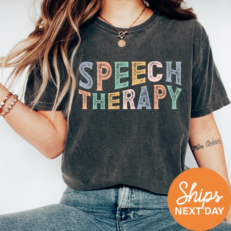 a woman wearing a t - shirt that says speech therapy