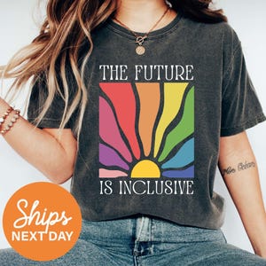 a woman wearing a t - shirt that says the future is inclusive