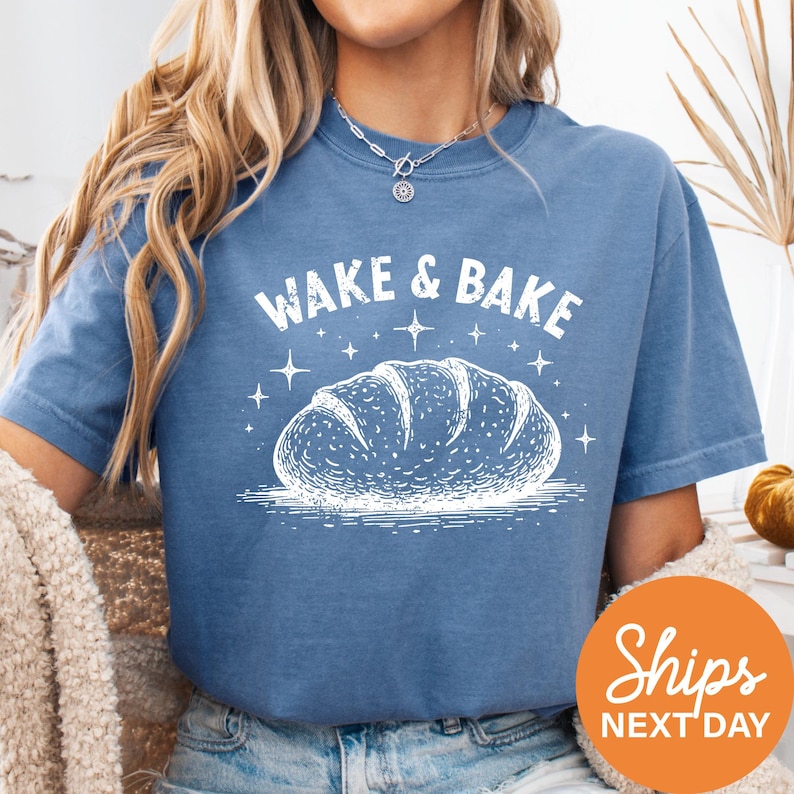a woman wearing a blue wake and bake t - shirt