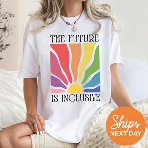 a woman sitting on a bed wearing a t - shirt that says the future is