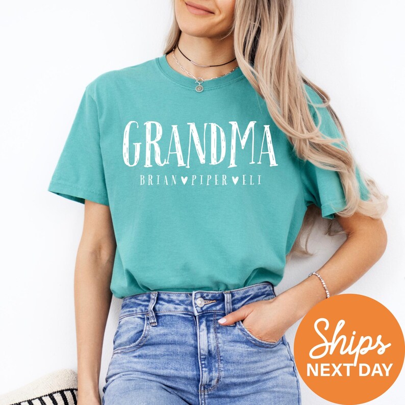 a woman wearing a green shirt with the words grandma on it