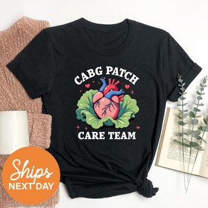 a black t - shirt with a picture of a heart on it