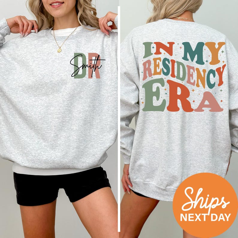 a woman wearing a sweatshirt that says, in my residence era