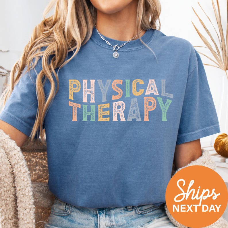 a woman wearing a blue physical therapy shirt
