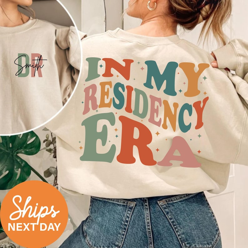 a woman wearing a sweatshirt that says, i'm my residence era