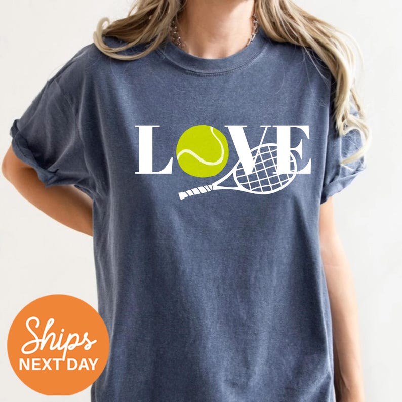a woman wearing a t - shirt that says love with a tennis racket