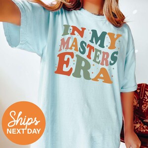 a woman wearing a t - shirt that says in my masters era