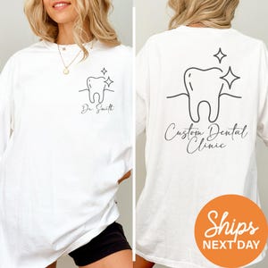 a woman wearing a white t - shirt with a tooth design on it