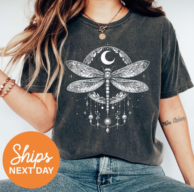a woman wearing a t - shirt with a dragon on it