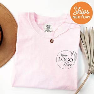 a hat, sunglasses, and t - shirt on a table