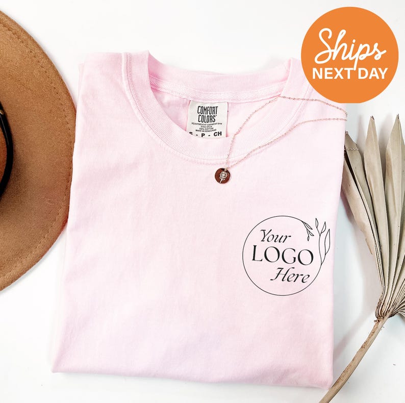 a hat, sunglasses, and t - shirt on a table