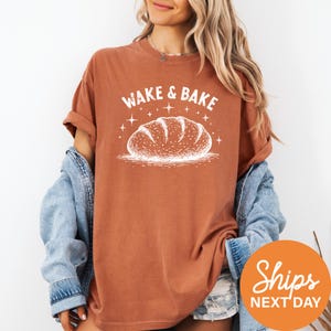 a woman wearing a t - shirt that says wake and bake