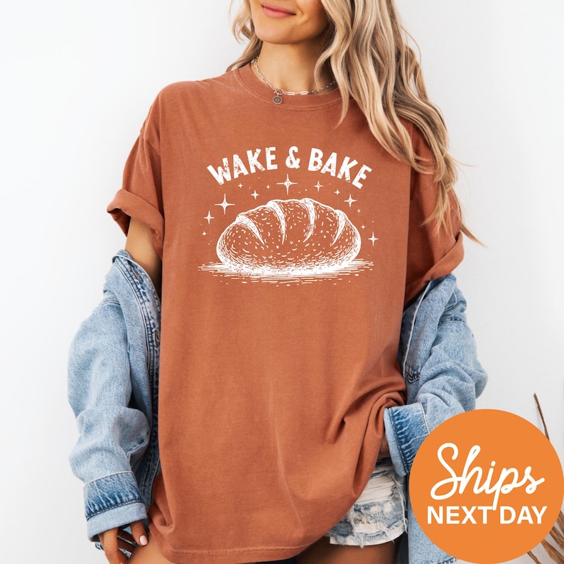 a woman wearing a t - shirt that says wake and bake