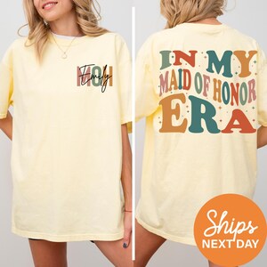 a woman wearing a yellow shirt that says, in my maid of honor era