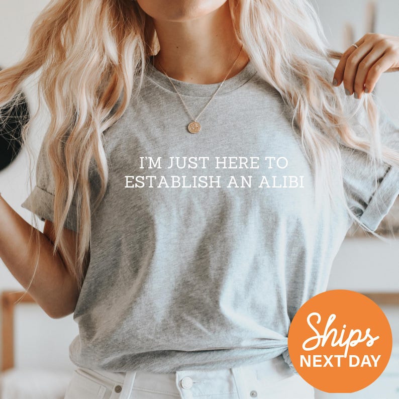 a woman wearing a t - shirt that says, i'm just here to