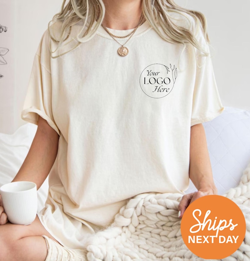 a woman sitting on a bed with a cup of coffee