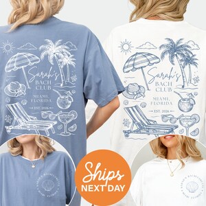 The image is a collage of three images featuring t-shirts with beach-themed designs. The t-shirts are blue and white, with illustrations of beach chairs, umbrellas, and palm trees. The text on the t-shirts reads "Sara's Bach Club Miami, Florida" and "Est. 2016". The collage also includes a text overlay that says "Shops NEXT DAY".